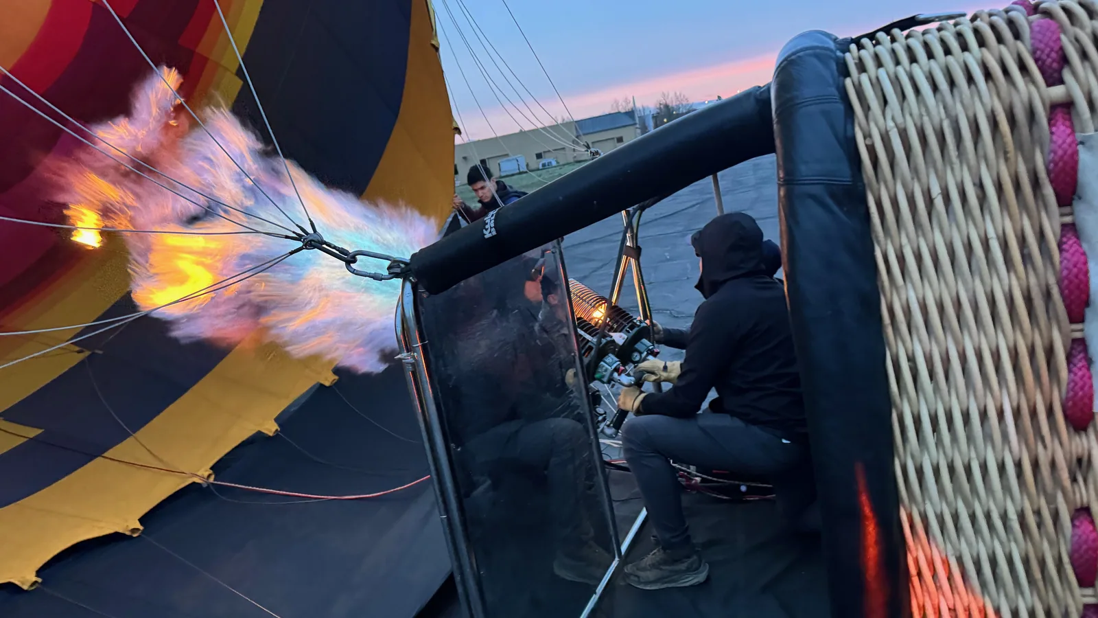 Sonoma Ballooning pilot at the burner with the crew and basket during a sunrise launch