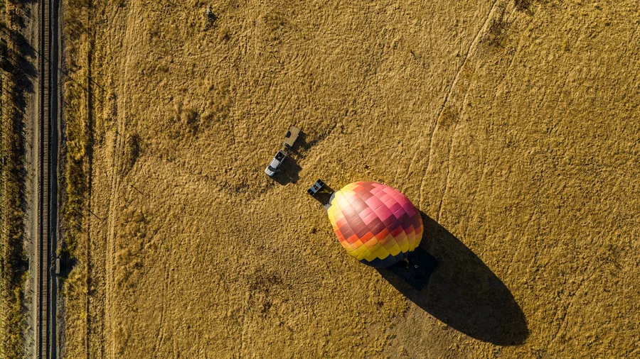 Hot air balloon envelope tipping over onto a Sonoma field after landing
