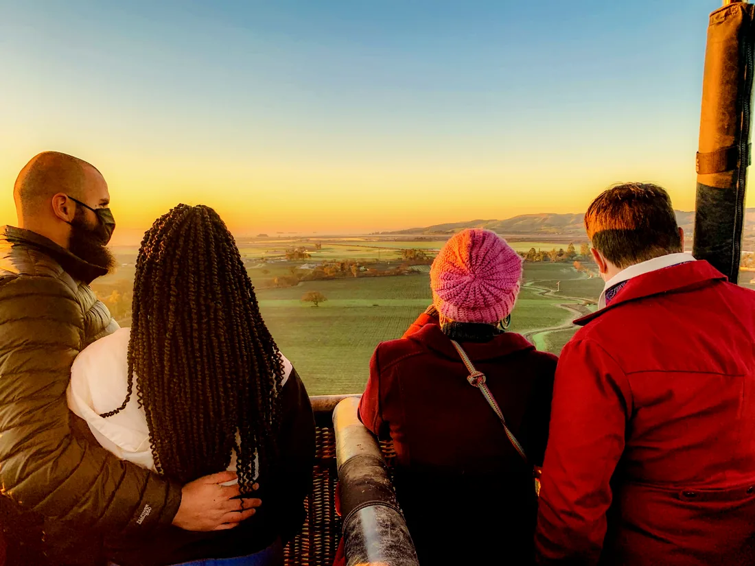 Guests taking in the sunrise from the balloon basket
